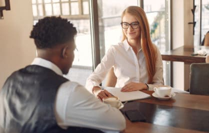 Man Being Interviewed By A Woman