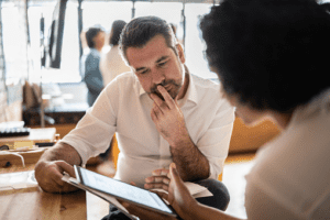 Man and women discussing on notebook